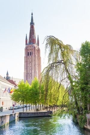 Church of Our Lady Bruges view from river canal during summer in Belgiumの写真素材