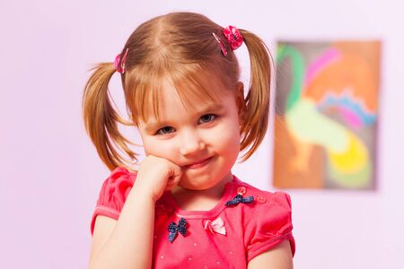 Close portrait of beautiful girl with ponytails looking at camera