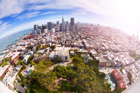 Fisheye view of San Francisco panorama skyscrapers and houses from the hill shot with wide angle lensの写真素材