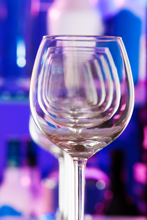 Set of wine glasses standing in a row one after another forming transparent perspective close-up shotの写真素材