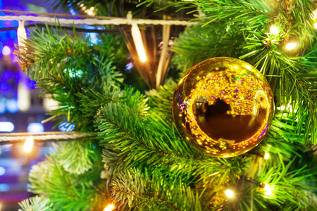 Christmas tree decorated with festive garland and sparkling golden bauble copy-space addedの写真素材