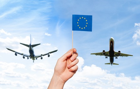 Mans hand holding European Union flag with poleの写真素材