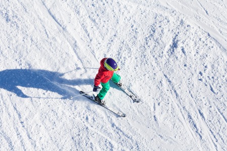 Top view portrait of boy riding fast on downhillの写真素材