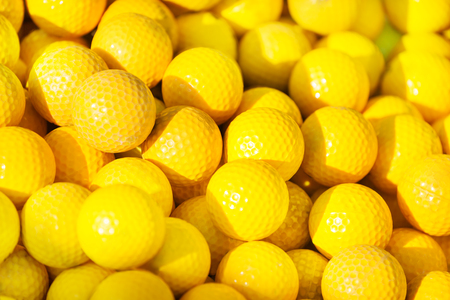Close-up picture of yellow golf balls pileの写真素材