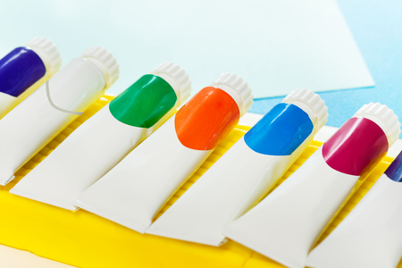 Small tubes of colored gouache laying in a lineの写真素材