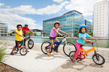 African children enjoying cycling together in townの写真素材