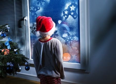 Boy expecting presents waiting for Christmasの写真素材