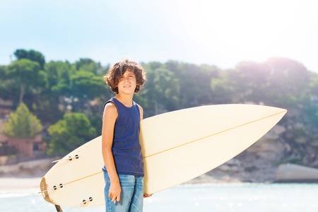 Portrait of cute teenage surfer with surf boardの写真素材