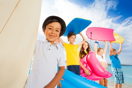 Portraits of many kids on the beach with boardsの写真素材