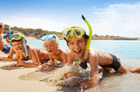 Happy screaming boys in scuba mask on the beachの写真素材