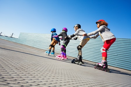 Happy preteen kids having fun while rollerbladingの写真素材