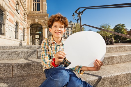 Cute boy sitting on the steps with speech bubble