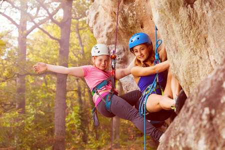 Two climbers abseiling training on steep rockの写真素材