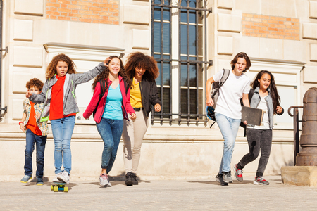 Happy teens having fun at college campusの写真素材
