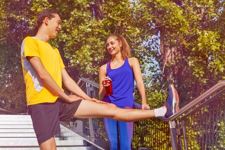 Sporty people preparing to jog in summer park
