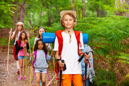 Boy portrait in group of friends hikingの写真素材