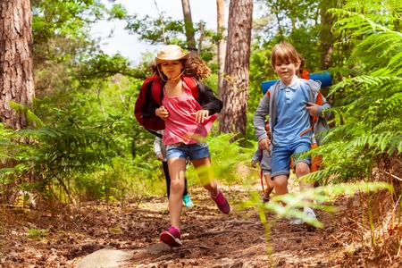 Boy and girl running in the forestの写真素材