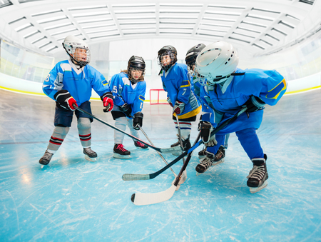 Childrens ice hockey team practicing on rinkの写真素材