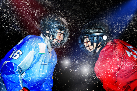 Young hockey players face-to-face at ice arenaの写真素材
