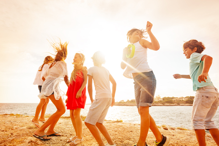 Happy teenagers having fun during beach partyの写真素材