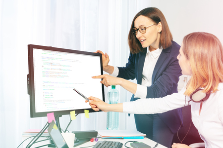 Women discussing business project in the officeの写真素材