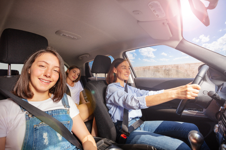 Mother and two teenage daughters during road trip