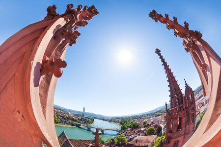 Fish-eye picture of the Rhine river embankment overlooking through the twin towers of the Basel Minster cathedral at sunny day, Switzerland, Europeの写真素材