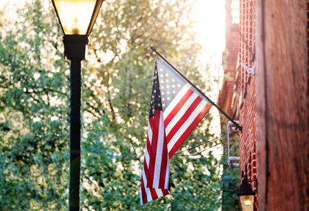 American flag on the red brick house in Baltimoreの写真素材