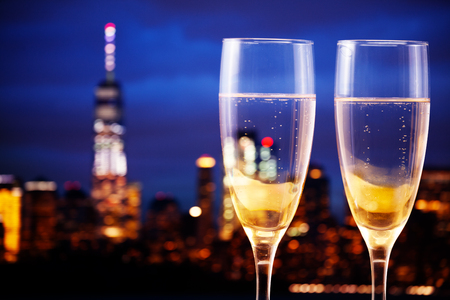 New York panorama night and glasses of champagneの写真素材