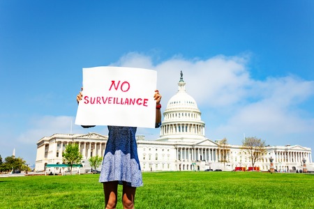 Protester holding in hands sign no surveillance