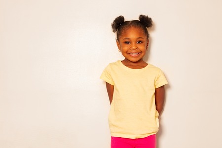 Portrait of nice little black girl smile over wallの写真素材