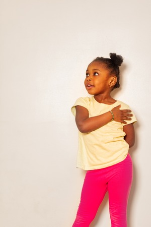 Little girl express herself with hand on shoulderの写真素材