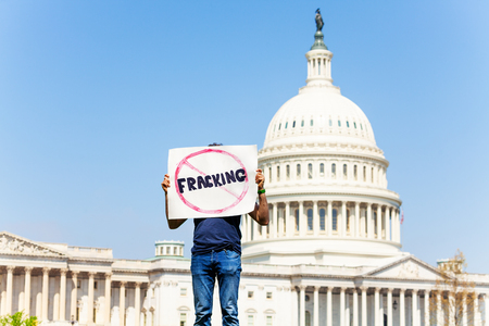 Protester holding sign no fracking for oil or gasの写真素材