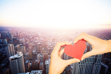 Hand hold red heart over Chicago city skylineの写真素材