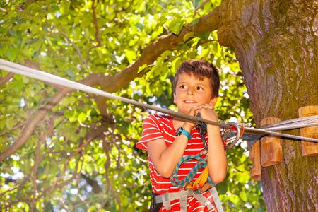 Close portrait of boy at adventure park near cableの写真素材