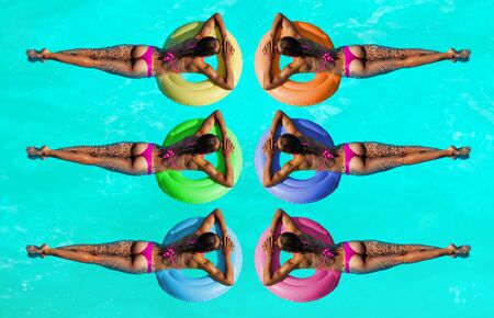 Women on inflatable different color buoys in waterの写真素材