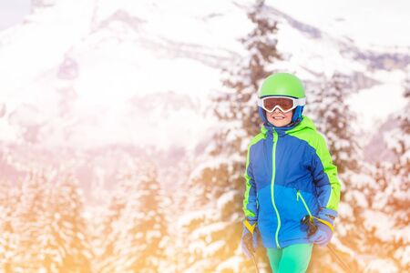 Close portrait of a boy over snow covered forestの写真素材