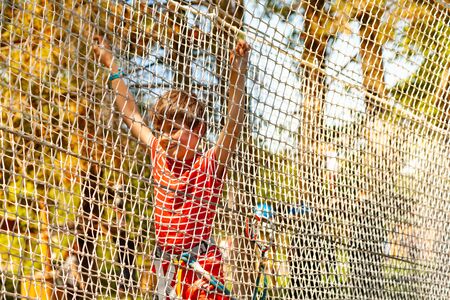 Little boy pass net at adventure rope parkの写真素材