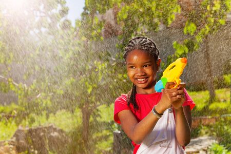 Portrait of smiling girl in water fight gameの写真素材