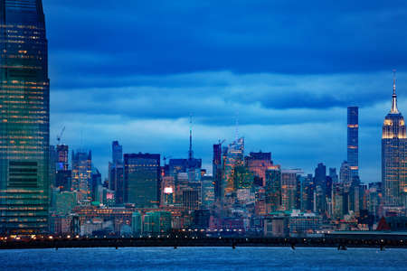 View of New York middle Manhattan downtown over Hudson river on moody overcast evening