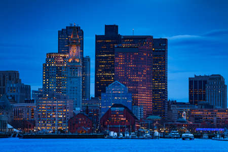 Dusk photo of Boston downtown from Main channel with marina and illuminated skyscrapersの写真素材