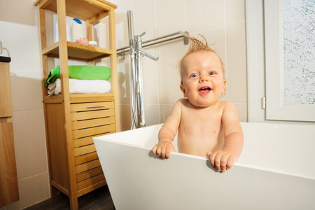 Beautiful happy portrait of the toddler in bathtubの写真素材