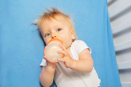 Toddler drink formula laying in the bed top viewの写真素材