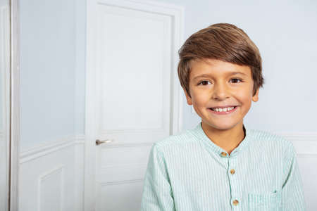 Calm positive portrait of little boy at home smileの写真素材