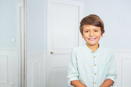 Positive portrait of little boy at home smilingの写真素材