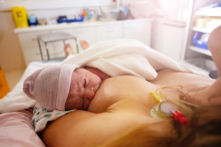 Close photo of mother breast feeding newborn babyの写真素材