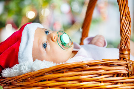 Close-up of a girl in basket under Christmas treeの写真素材