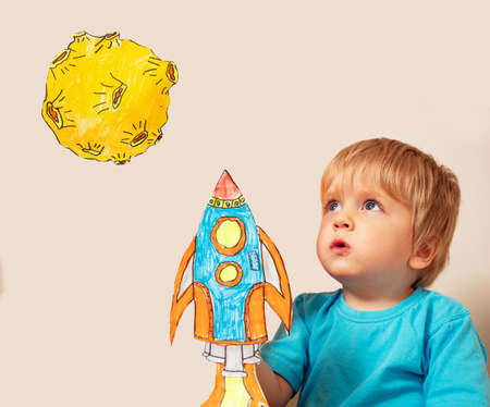 Cute young toddler play rocket land on a planetの写真素材