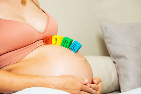 Pregnant woman with color blocks making girl wordの写真素材