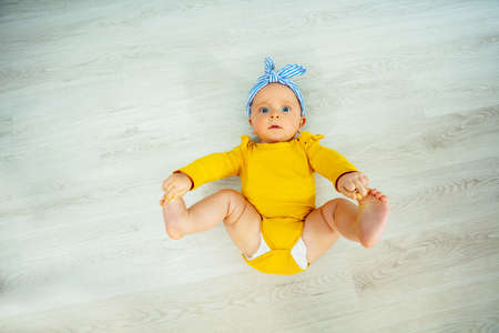 Little baby girl with blue bow view from aboveの写真素材